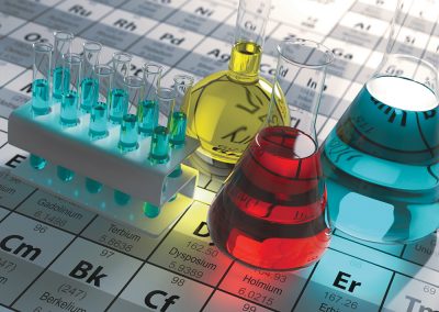 Laboratory test tubes and flasks with colored liquids on the periodic table of elements.